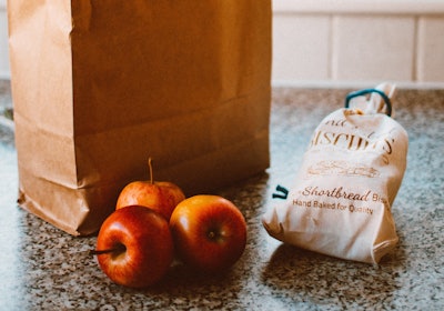 Several Apples Beside Bread Pack And Brown Paper Bag 1992912