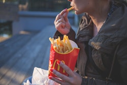 Woman In Brown Classic Trench Coat Eating Mcdo Fries During 139681