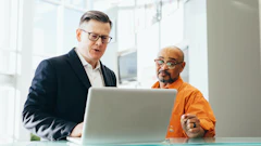 Man Using Silver Laptop Beside Another Man 2182973