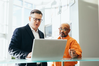 Man Using Silver Laptop Beside Another Man 2182973