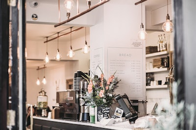 Inside The Restaurant With Pendant Lamps And Flowers 704982
