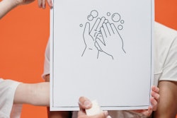 Person Holding A Poster On Proper Hand Washing 3952223