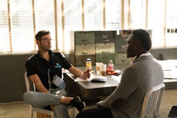 Man Wearing Black Polo Shirt And Gray Pants Sitting On White 935977