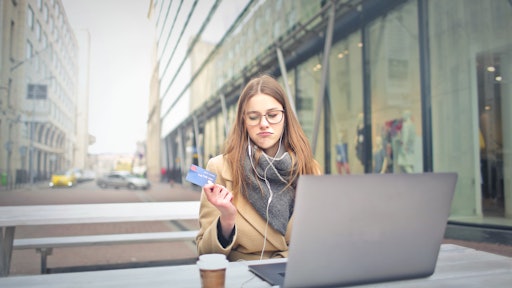 Woman In Brown Coat Holding A Bank Card 3784391