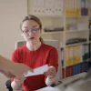 Young Woman Examining Document In Office 3770194