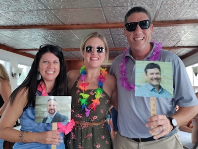 Left to right: Marina Mayer, editor-in-chief (holding up picture of Mike Coon, sales executive, who could not make it); Brielle Jaekel, associate editor; Jason DeSarle, group publisher (holding up picture of Brian Hines, sales executive, who could not make it). Not pictured: Mackenna Moralez, assistant editor.