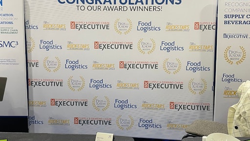 The backdrop of our booth for our awards winners.