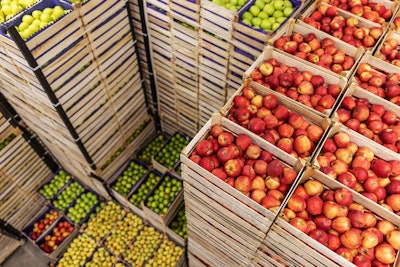 Perishable fruit and vegetables stacked for warehousing.