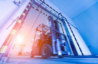 A forklift sorts through a cold storage warehouse.