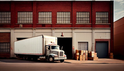 A loaded truck waits at a warehouse.