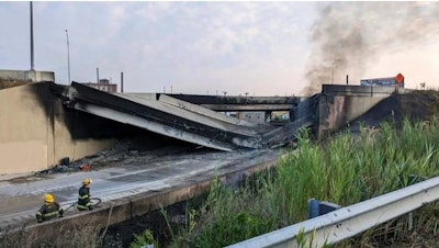 This image provided by the Office of Emergency Management shows firefighters standing near the collapsed part of I-95 in Philadelphia, Sunday, June 11, 2023.
