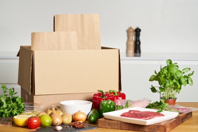 A delivery box opened to contain fresh food and produce.