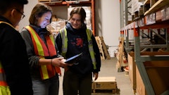 Routique Team In Warehouse Checking Inventory On Tablet