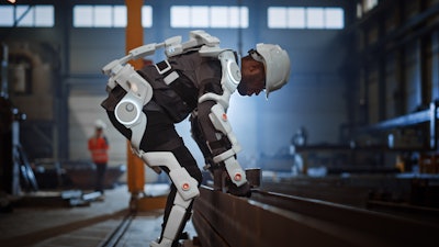Worker wears an exoskeleton to assist.
