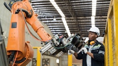 Industrial robotic arm working with a human.