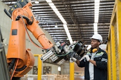 Industrial robotic arm working with a human.