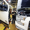 In this Nov. 6, 2014 photo, Shawn Ebeler works on the door assembly on a new Ford F-150 truck is assembled at the Dearborn Truck Plant in Dearborn, Mich. It’s Ford Motor Co.’s biggest bet in decades: an aluminum-sided F-150 that could set a new industry standard _ or cost the company its pickup truck crown. (AP Photo/Carlos Osorio)