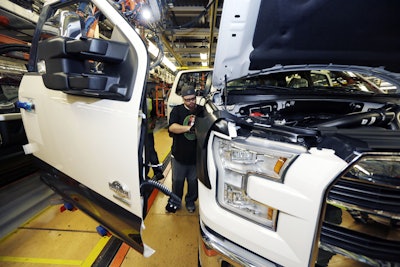 In this Nov. 6, 2014 photo, Shawn Ebeler works on the door assembly on a new Ford F-150 truck is assembled at the Dearborn Truck Plant in Dearborn, Mich. It’s Ford Motor Co.’s biggest bet in decades: an aluminum-sided F-150 that could set a new industry standard _ or cost the company its pickup truck crown. (AP Photo/Carlos Osorio)