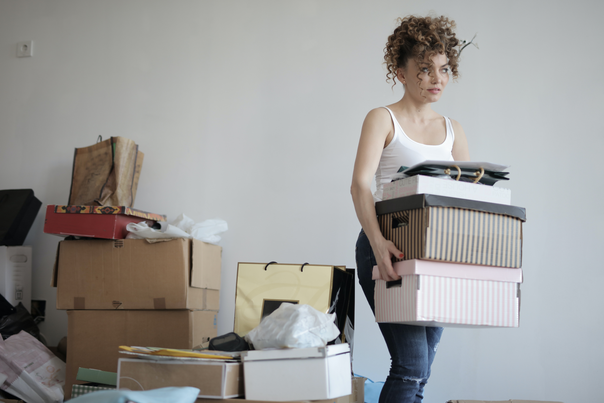 Concentrated Woman Carrying Stack Of Cardboard Boxes For 3791617