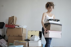 Concentrated Woman Carrying Stack Of Cardboard Boxes For 3791617