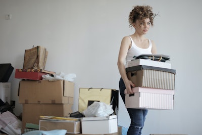 Concentrated Woman Carrying Stack Of Cardboard Boxes For 3791617