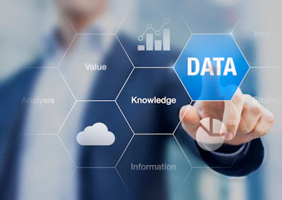 Business professional pointing to data analytics concept with hexagonal icons showing knowledge, value, and information flow
