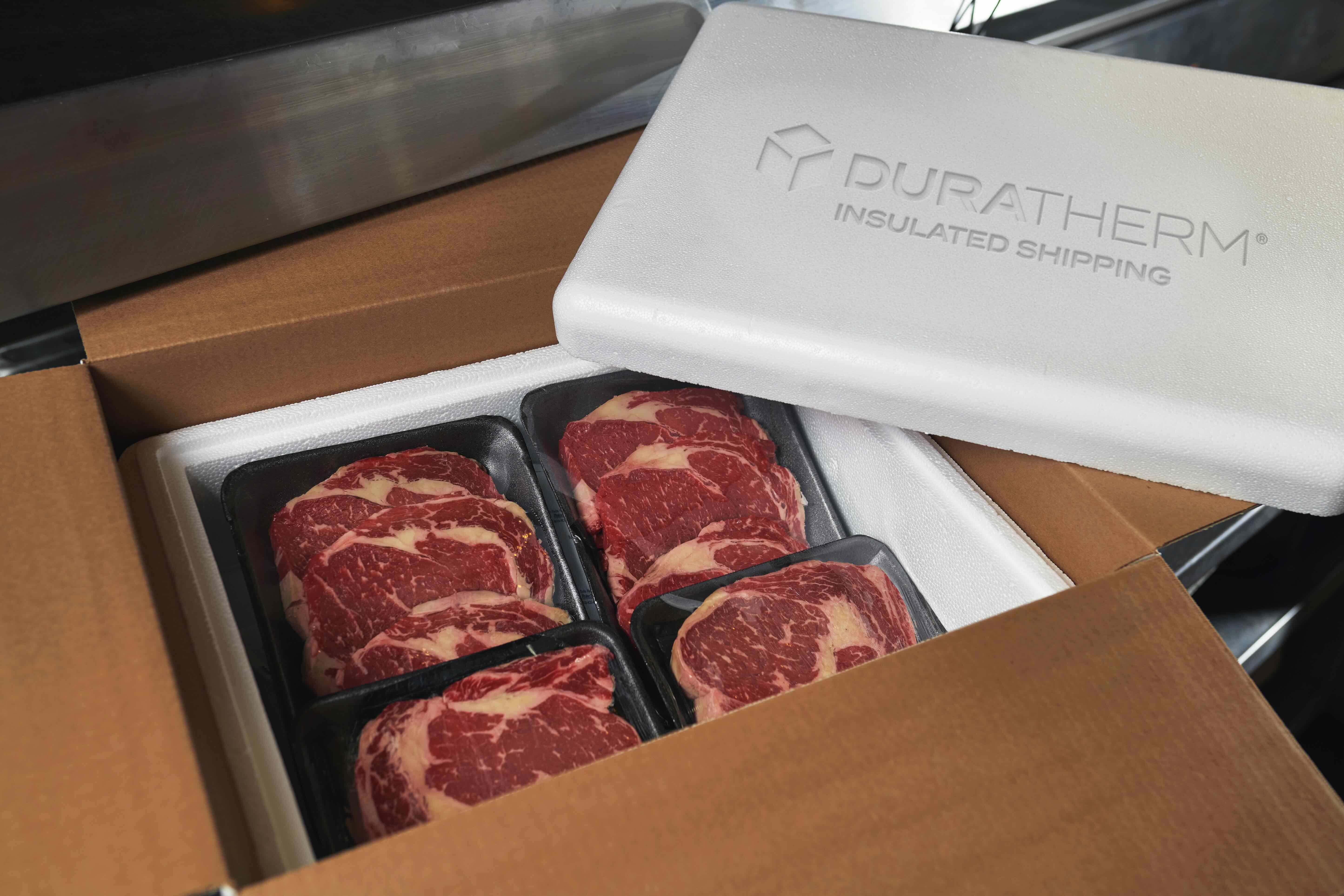 Puratherm insulated shipping box containing premium beef steaks in black trays