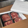 Puratherm insulated shipping box containing premium beef steaks in black trays
