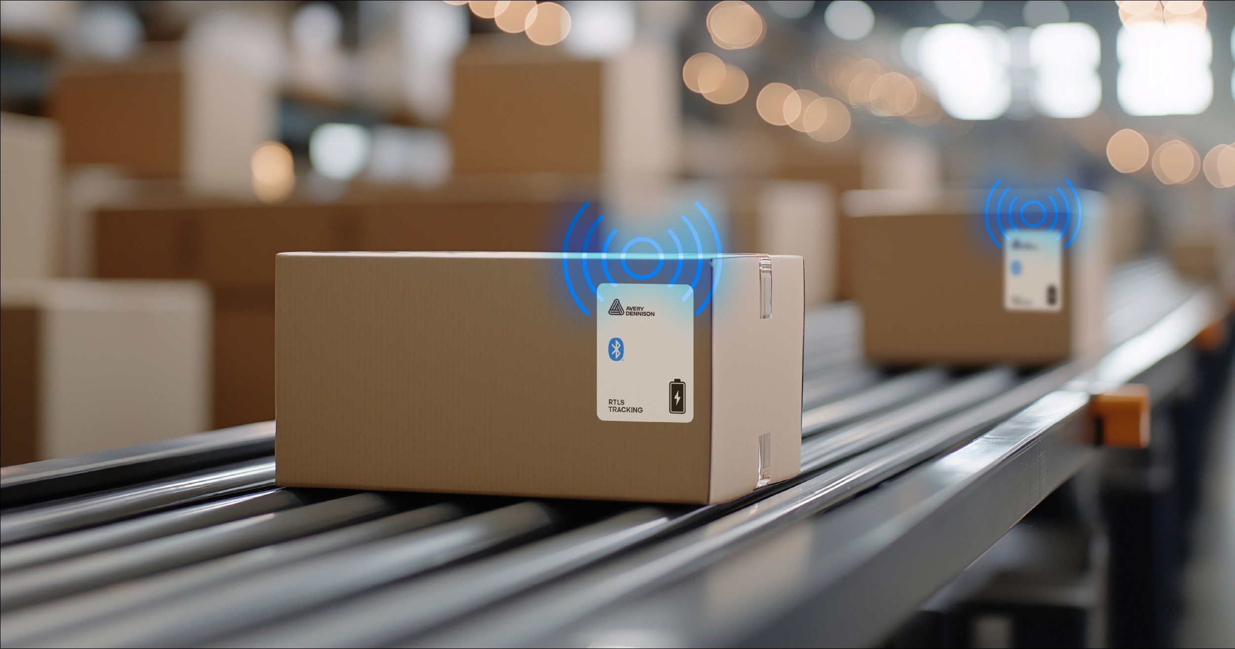 Cardboard boxes with Bluetooth tracking labels on warehouse conveyor belt with wireless signal indicators