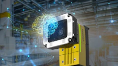 Industrial vision camera with white and black housing mounted on yellow equipment in a smart factory warehouse with digital network visualization