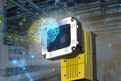 Industrial vision camera with white and black housing mounted on yellow equipment in a smart factory warehouse with digital network visualization