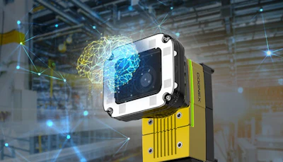 Industrial vision camera with white and black housing mounted on yellow equipment in a smart factory warehouse with digital network visualization