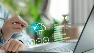 Person interacting with cloud computing analytics dashboard displaying neon icons, data charts, and performance metrics on laptop screen