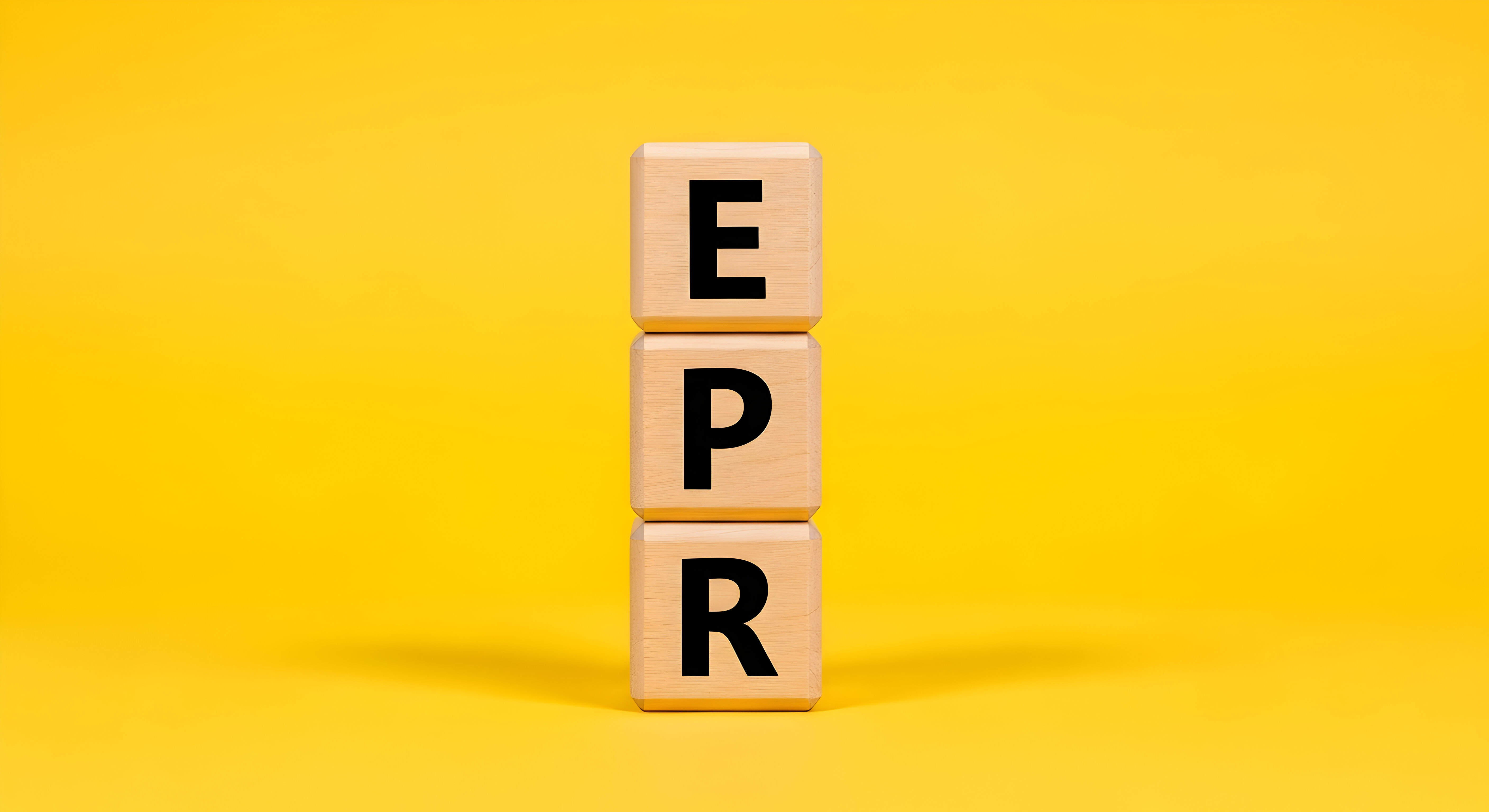 Three wooden letter tiles stacked vertically spelling EPR on yellow background