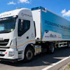 White IVECO refrigerated truck branded with NIVALIS cold chain logistics company branding, parked on a rural road with green landscape and blue sky.