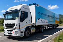 White IVECO refrigerated truck branded with NIVALIS cold chain logistics company branding, parked on a rural road with green landscape and blue sky.