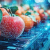 Red apple with digital wireframe overlay on circuit board background representing technology and agriculture integration