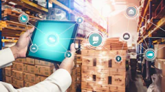 Warehouse worker holding tablet with digital logistics and supply chain management icons overlay