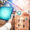 Warehouse worker holding tablet with digital logistics and supply chain management icons overlay