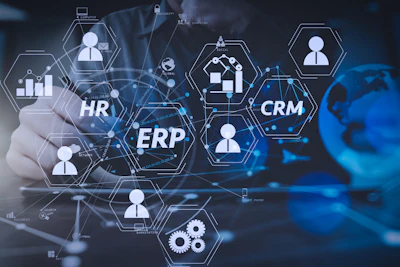 Digital illustration of interconnected enterprise systems showing HR, ERP, and CRM modules with user icons and network connections on a blue tech background