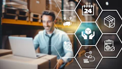 Man working on laptop in warehouse with supply chain logistics icons representing delivery, tracking, and quality management