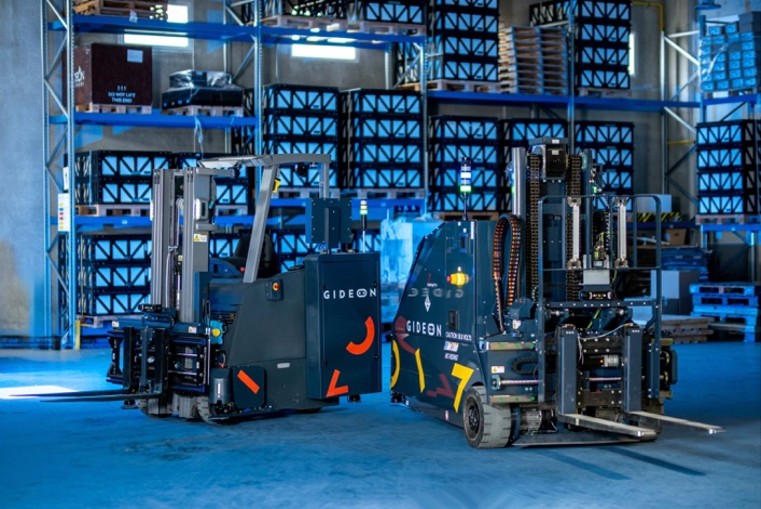 GIDEON branded forklifts displayed in a modern blue-lit warehouse with stacked plastic crates
