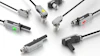 Collection of SICK industrial sensor connectors and M12 cable connectors in various configurations with black and gray housings