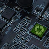 Green recycling symbol on computer circuit board with electronic components
