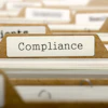 Compliance folder tab in organized file system with other labeled documents